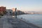 Wide view of embankment and beach at early morning on the Loutraki embankment with a dog