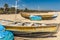 Wide view of fishing boats parked alone in seashore with tress and mountain in the background, Visakhapatnam, India March 05 2017