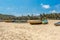 Wide view of fishing boats parked alone in seashore with tress and mountain in the background, Visakhapatnam, India March 05 2017