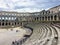 A wide view of a group of tourists admiring the view inside the Pula Theatre in Pula