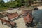 Wide view of group of unoccupied wooden seats or chairs arranged in a garden or park, Chennai, India, April 1st 2017