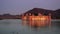wide view of jal mahal water palace illuminated in jaipur at dusk