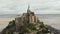 Wide View of Le Mont Saint Michel Castle in the Ocean in France, Aerial, Cloudy