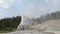 A wide view of lone star geyser erupting in yellowstone national park