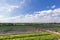 Wide view of many vegetable plots and blue sky