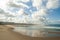 Wide view of the ocean beach during low tide clouds reflected in the wet sand - Espinho, Portugal