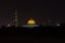 A Wide view of the Sultan Qaboos Grand Mosque and Al Ameen Mosque in Muscat, Oman at night showing off and glowing dome colours