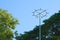 A wide view of an unidentified park pole structure of unknown purpose, standing tall, under a light blue sky.