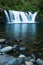 Wide waterfall over calm pool smoothed with long exposure