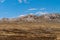 Wide windswept sloping landscape with rocky outcrop on Falklands, UK