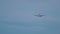 Widebody airplane approaching over ocean