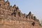 Widening view of Borobudur at the base with plenty of small stupas and buddha statues