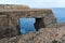 Wied il Mielah canyon, natural arch over the sea. Gozo, Malta