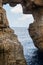 Wied il Mielah canyon, natural arch over the sea. Gozo, Malta