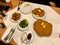 Wiener Schnitzel, Pork Cutlet, Austrian Cuisine. Served with Cold Potatoes and Rucola Salad at Restaurant Table