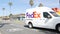 Wienerschnitzel hot dog fast food. FedEx delivery, Federal Express truck. California route 101, USA.