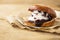 Wierd burger with vanilla ice cream and chocolated confetti on wooden background.