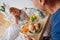 Wife feeling truly pleased seeing husband brining breakfast in bed