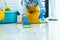 Wife housekeeping and cleaning concept, Happy young woman in blue rubber gloves wiping dust using a spray and a duster while