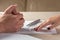 Wife and husband signing divorce documents, woman returning wedding ring