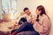 Wife and husband sitting on floor having first dinner in new room