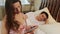 Wife secretly checking photos on tablet while her husband sleeps