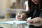 Wife signing divorce document at home