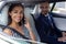 Wife speaking by phone while sitting near husband in car