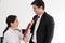 Wife tying red necktie to her husband in the office with smiling and happy