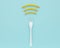 Wifi symbol creative idea layout made of fork with french fries on blue color background. minimal food idea and Internet technolog