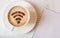 WiFi symbol made of cinnamon powder as coffee decoration on cup of cappuccino.