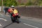 WIGAN, UK 14 SEPTEMBER 2019: A photograph documenting a race support motorbike leading the Tour of Britain 2019 race as it passes