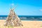 Wigwam Made from wooden branches on the sand of baltic sea beach