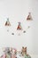 Wigwam shaped shelves, stuffed toys and garland indoors. Children`s room interior design