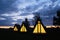 Wigwams against the sunset sky. A hause