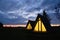 Wigwams against the sunset sky. A hause