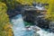 Wild Abisko river flows swiftly through rocky gorge in Abisko National Park deep in the Swedish Arctic. Autumn colors in