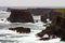 The wild Atlantic Ocean crashes against the sea stacks, rocks, a