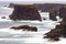 The wild Atlantic Ocean crashes against the sea stacks, rocks, a