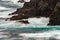 The wild Atlantic Ocean crashes against the sea stacks, rocks, and coastline