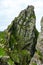 Wild Atlantic Way: Climbers at base of immense weather-beaten jagged peak above `Christ`s Valley,` on Skellig Michael.