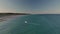 Wild beach and boats in turquoise sea