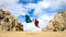 Wild beach in lower California of Mexico. Rocky formations on yellow sand against a blue sky with white clouds and Mexican flag. B