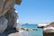 Wild beach on the Mediterranean coast. Empty pebbles beach, turquoise sea and rocks.