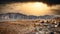 Wild beach over mountains and dramatic sky.