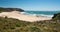 Wild beach on seaside of Portugal. Sunny sand area and ocean waves at nice day