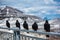 Wild birds line up on the handrail with the background of Passo