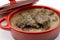 wild boar stew with pepper sauce on a white background