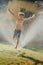 Wild boy jumping in sprinklers