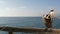 Wild brown pelican on pier, California ocean beach USA. Coastal pelecanus, big bird. Large bill beak